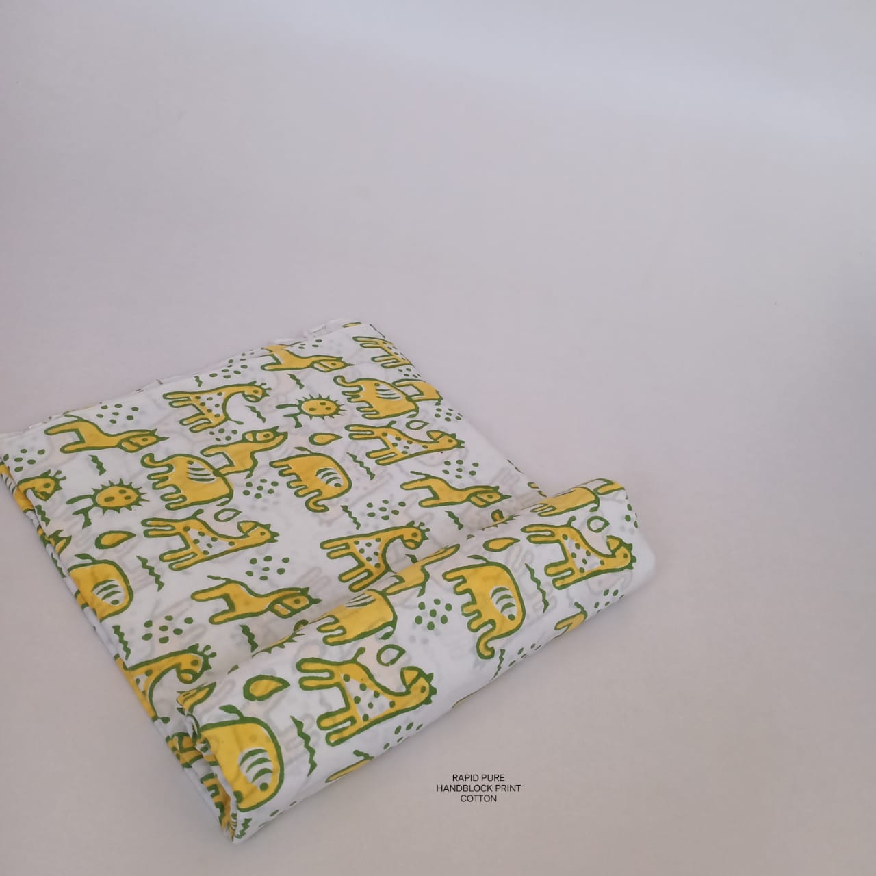 Wholesale Jaipur Sanganeri Handblock Cotton Fabric in white and yellow featuring horse and camel print, slow-made and B2B-ready.